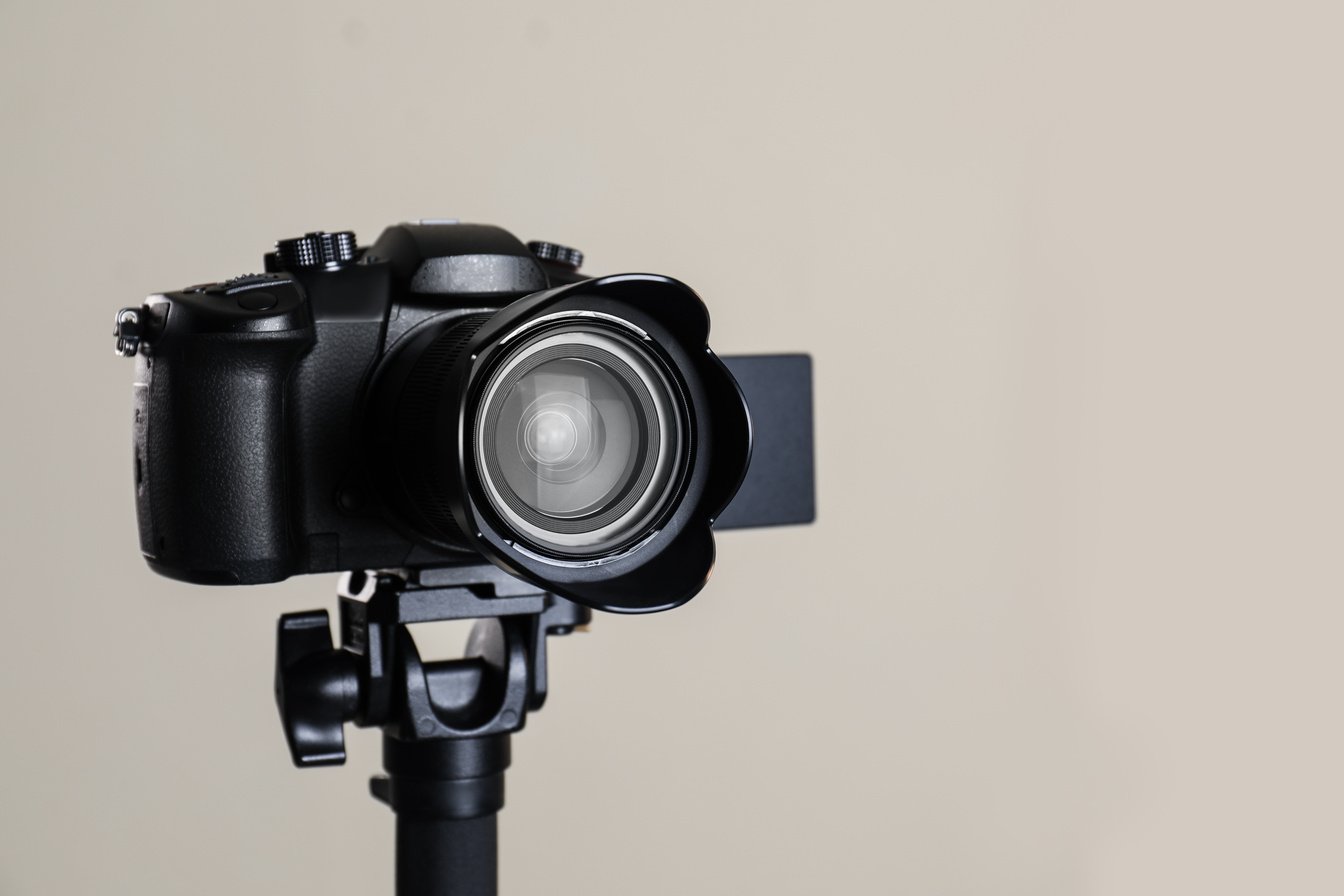 Modern Professional Video Camera on Beige Background